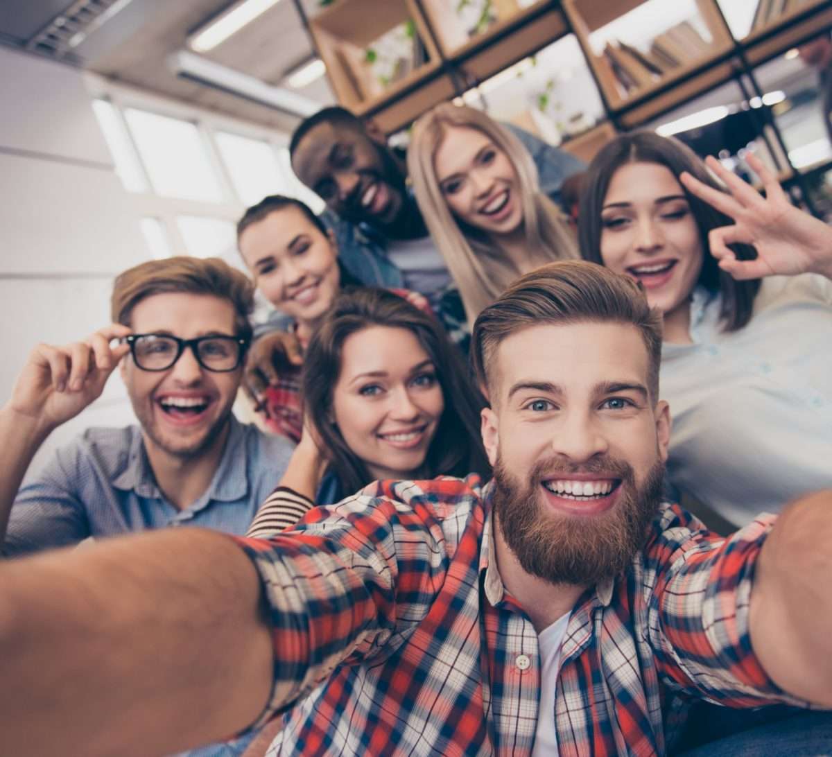 un groupe de jeunes personnes fait un selfie